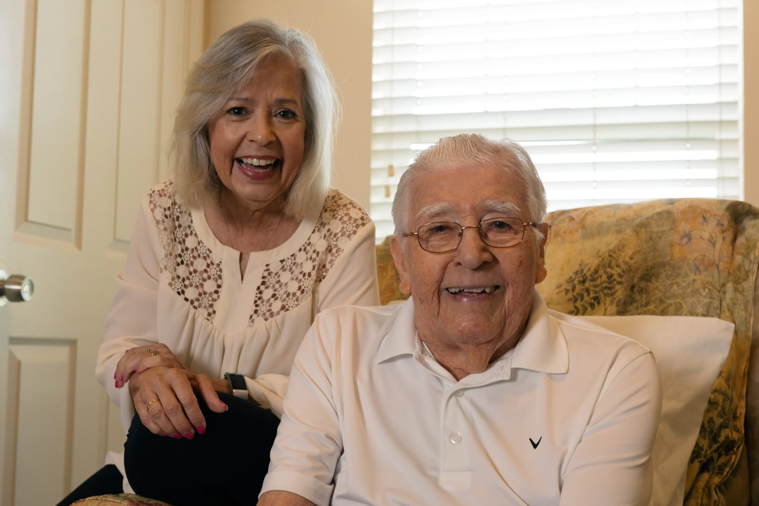 Two Senior Citizens smiling at the camera